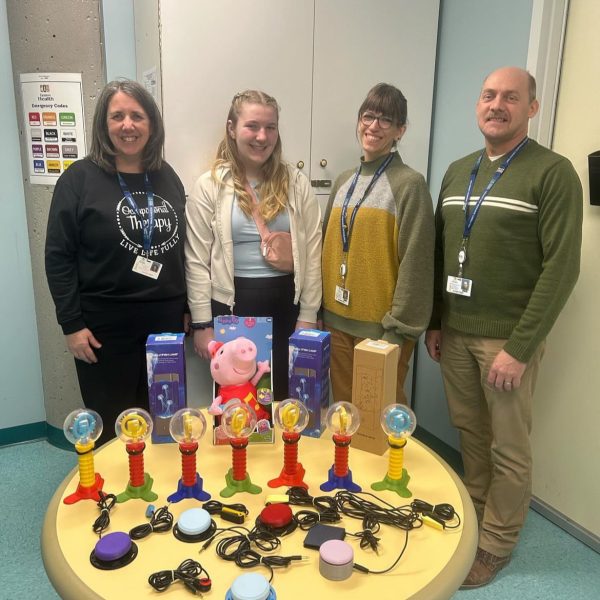 IMG_0958 Natalie with fellow volunteers showcasing modified toys from Tech for Community